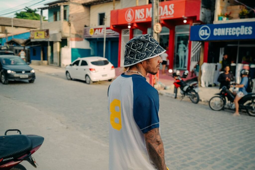 De costas, Lewis Hamilton posa em rua de Trancoso, na Bahia