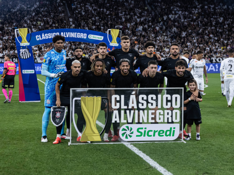 Torcedor do Corinthians com o rosto pintado e cachecol, vibrando em estádio lotado.