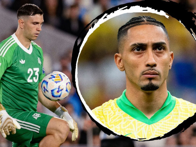 Imagem de Dibu Martínez encarando Raphinha em campo durante jogo entre Argentina e Brasil.