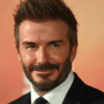 David Beckham celebrando seu 50º aniversário com um terno elegante e champanhe em um terraço de luxo.