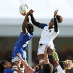 Close-up ultrarrealista da capitã das Yaras, Eshyllen Coimbra, em campo durante a Copa do Mundo de Rugby XV de 2025, com expressão de determinação.
